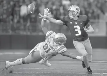  ?? Photograph­s by Elaine Thompson Associated Press ?? JAKE BROWNING threw for just 98 yards vs. Jacob Tuioti-Mariner and UCLA, but he got plenty of help.