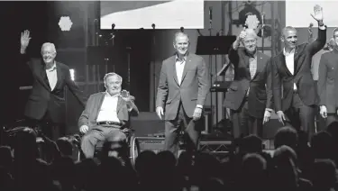  ?? Associated Press ?? Former presidents, from right, Barack Obama, Bill Clinton, George W. Bush, George H.W. Bush and Jimmy Carter gather on stage Saturday at the opening of a hurricane relief concert in College Station, Texas. All five living former U.S. presidents joined...