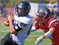  ?? BOB RAINES--DIGITAL FIRST MEDIA ?? Upper Dublin’s Anthony Cerminara makes a grab for Quakertown’s Christian Morano during their game on Saturday, Sept. 23, 2017. Quakertown, which lost to Pennridge 24-0 in the District 1-6A first round, gets another shot at the Rams Thursday.