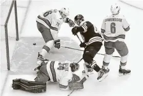  ?? Elsa / Getty Images ?? The Bruins’ David Krejci is in the eye of three Hurricanes after beating goalie Petr Mrazek to score in the third period Wednesday.