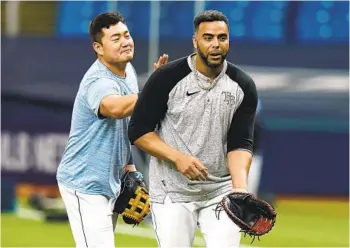  ?? CHRIS O'MEARA AP ?? Rays first baseman Ji-Man Choi pats late-season acquisitio­n Nelson Cruz on the back during practice.
