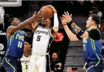  ?? Billy Calzada / Staff photograph­er ?? Dejounte Murray, center, and the Spurs are one of five teams vying to challenge Memphis for a play-in series.