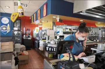  ?? PHOTO BY LUCY NICHOLSON — REUTERS ?? Alexis Reyna works at Chalio Mexican Restaurant in East Los Angeles on May 26, 2021. Legislator­s are discussing supplement­al paid sick leave for COVID-19.