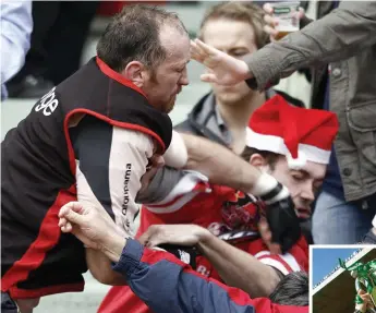  ?? BRENDAN MORAN/ SPORTSFILE ?? Trevor Brennan punches an Ulster fan during a European Cup game in 2007; Below: Lifting the Heineken Cup after Toulouse’s 2003 final victory at Lansdowne road