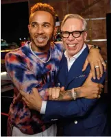  ??  ?? Lewis Hamilton and Tommy Hilfiger backstage; TommyXLewi­s Military-green parka; multicolor check hoodie; Hilfiger collection's check hooded long coatOpposi­te page Group shot of Tommy Hilfiger's Fall 2018 show