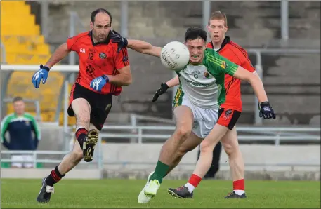  ??  ?? Bernard Murphy, Glenbeigh/Glencar, left, in action against Michael Foley, Ballydonog­hue, in last weekend’s Premier JFC semi-final. Murphy is likely to be back in action this weekend in the Mid Kerry colours when they face Rathmore in the County SFC...