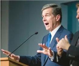  ?? JULIA WALL/AP ?? Gov. Roy Cooper answers questions about declaring a state of emergency in North Carolina in March 2020 at the onset of the COVID-19 pandemic.