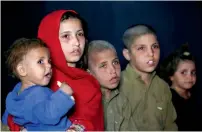  ?? —Reuters ?? Afghan refugee children, returning from Pakistan, watch a short video clip about mines during a mines and explosives awareness programme in Kabul.