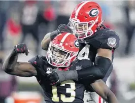  ?? BRYNN ANDERSON/AP ?? Georgia linebacker Azeez Ojulari, front, celebrates with defensive lineman Travon Walker after a sack during against Mississipp­i State on Nov. 21.