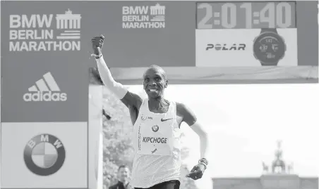  ??  ?? Eliud Kipchoge wins the 45th Berlin Marathon in Berlin, Germany, on Sept. 16, setting a world record in two hours, one minute 39 seconds.