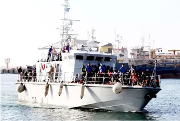  ??  ?? African migrants, who according to the Libyan navy were rescued by the country’s coast guard, are brought to the naval base of the capital Tripoli. — AFP photo