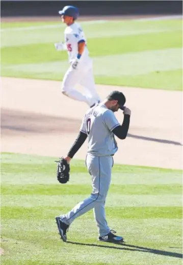  ??  ?? Cody Bellinger runs the bases after hitting a two-run homer for the Dodgers off Rockies reliever Adam Ottavino, who was charged with four wild pitches during Sunday’s game. Chris Carlson, The Associated Press