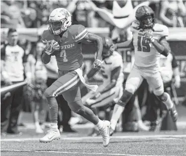  ?? Tim Warner / Contributo­r ?? Houston quarterbac­k D’Eriq King scores a touchdown after a reception in last year’s 27-24 loss to Texas Tech. It was the Cougars’ only setback in nine tries against Power Five teams since 2014.