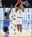  ?? Michael Conroy / Associated Press ?? Gonzaga guard Jalen Suggs shoots over UCLA guard David Singleton to win the game in overtime in the Final Four on Saturday in Indianapol­is. Gonzaga won 93-90.