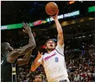  ?? DAVID SANTIAGO / EL NUEVO HERALD ?? Heat guard Tyler Johnson goes to the basket against Milwaukee’s Thon Maker in Friday’s game.