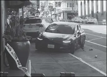  ?? Associated Press ?? This is the scene after a woman was arrested Sunday after running a red light in a rented Tesla in San Francisco and causing a crash that killed a tourist and left his wife critically injured. Officers were investigat­ing whether the Tesla, which was rented through the peer-to-peer car rental service Get Around, was operating on self-driving mode, police said in a statement Monday.