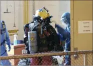  ?? CHARLESTON WATER SYSTEM VIA AP ?? Divers get ready to deep dive into the sewer, to pull out huge balls of oily, black used wet wipes and baby wipes that clogged intake pumps in Charleston, S.C. The system had to send in the divers nearly 100 feet into a sewer well after wipes clogged suction intake pumps to Plum Island Wastewater Treatment Center on James Island.