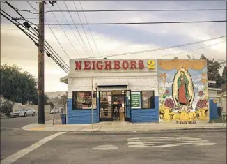  ?? Photograph­s by Jason Armond Los Angeles Times ?? A STORE in the heart of Westside Verdugo territory features a mural of the Virgin of Guadalupe. The gang is rooted in a collection of large families. “That’s all they know,” said one expert.