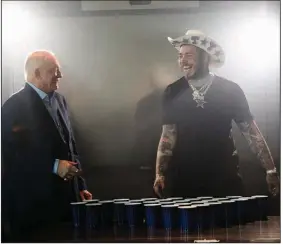  ?? (AP file photo) ?? Dallas Cowboys owner Jerry Jones (left) and singer/rapper Post Malone take a break between takes for the 2021 Dallas Cowboys schedule release video at The Star in Frisco, Texas in April 2021. Schedule release day has become a competitio­n across the NFL between the social media department­s of teams to see whose video creates the biggest impression.