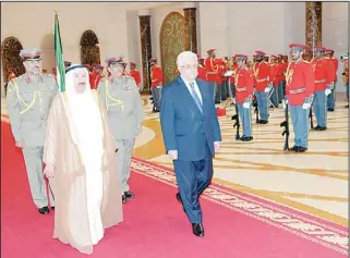  ?? KUNA photo ?? His Highness the Amir and President Mahmoud Abbas inspecting the guard of honor.