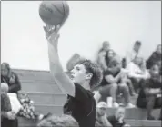  ?? Photos by Keith Reigel ?? Sam Lundeen gets a jump shot off during the Championsh­ip game with Sheffield at the Sheffield Holiday Tournament December 27 & 28.