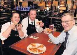  ??  ?? Great grub Di Maggio’s staff enjoy a pizza the action