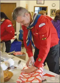  ?? NEWS PHOTO MO CRANKER ?? Rob Ewert spent his Saturday afternoon wrapping gifts for kids at the annual Santa's Gone Toonie event, held by the Redcliff Scouts.