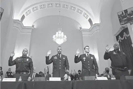  ?? POOL PHOTO BY ANDREW HARNIK ?? From left, Aquilino Gonell, Michael Fanone, Daniel Hodges and Harry Dunn, police who fought to defend the Capitol on Jan. 6, are sworn in Tuesday.