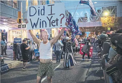  ?? CHRIS MCGRATH GETTY IMAGES ?? Donald Trump supporters protest outside the Philadelph­ia Convention Centre as votes continued to be counted Thursday evening. In the crucial battlegrou­nd of Pennsylvan­ia, Trump’s lead had been shrinking all day, Rosie DiManno writes.