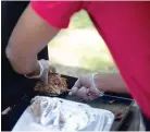  ??  ?? ■ Keyon Cooksey, aka Chef Key, cooks his birria-style tacos on Wednesday at Spring Lake Park. Cooksey says his version is not authentic to the tacos found in Mexico, but his customers do not seem to mind. “Tweaked it my own way,” Cooksey said. “They’re not authentic. “It’s my version, it’s my twist. I’ve used what I’m accustomed to, which
is beef, pork and chicken. It’s jumped off. It was a super hit, you know.”