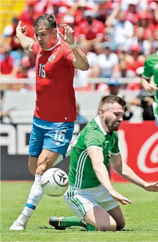  ??  ?? El tico Cristian Gamboa sortea la marca del norirlandé­s Stuart Dallas. Los europeos plantearon seria resistenci­a, pero la casa exhibió pegada y buena pelota parada.