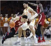  ?? WADE PAYNE — THE ASSOCIATED PRESS ?? Alabama guard Jahvon Quinerly (5) collides with Tennessee forward Olivier Nkamhoua (13) during the first half Wednesday in Knoxville, Tenn.