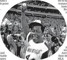  ?? AP ?? Aaron holds the ball he hit for his 715th career home run on April 8, 1974, in Atlanta Stadium against the Los Angeles Dodgers.