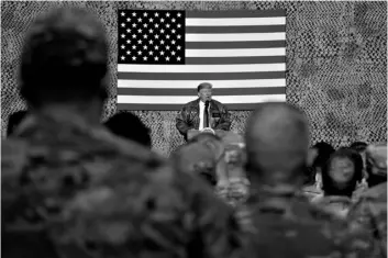  ?? AP Photo/Andrew Harnik, ?? In this 2018 file photo, President Donald Trump speaks to members of the military at a hangar rally at Al Asad Air Base, Iraq.