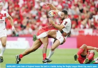  ?? — AFP ?? AUCKLAND: Luke Gale of England looses the ball in a tackle during the Rugby League World Cup men’s semifinal match between Tonga and England at Mt Smart Stadium in Auckland yesterday.