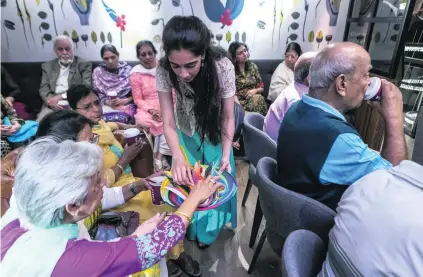  ?? Antonie Robertson / The National ?? Members of the Golden Age group enjoy quilling at Costa Cafe on Jumeirah Beach Road as part of the Alzheimer’s Cafe initiative. Talks, arts and crafts and workshops are planned to help address living with the condition.