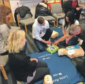  ??  ?? Lochgilphe­ad Soccer Centre volunteers receive training on how to use a defibrilla­tor.