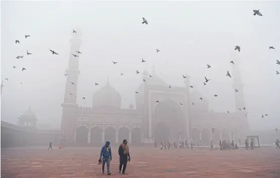  ?? SAJJAD HUSSAIN/AFP ?? La Jama Masjid, una de las principale­s mezquitas de la India, se recorta sobre un fondo de sombras en Delhi