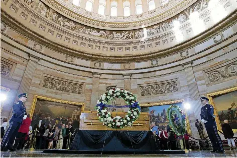  ?? [AP PHOTO] ?? Visitors pay their respects as the casket of Reverend Billy Graham lies in honor at the Rotunda of the U.S. Capitol Building in Washington on Wednesday.