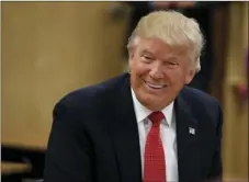  ??  ?? Republican presidenti­al candidate Donald Trump smiles as he meets with students and educators before speaking about school choice Thursday at Cleveland Arts and Social Sciences Academy in Cleveland. AP PHOTO/EVAN VUCCI