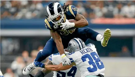  ?? USA TODAY ?? LA Rams running back Todd Gurley hurdles a Dallas Cowboys defender.