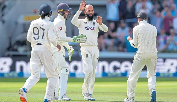  ??  ?? NOT OVER: England’s Moeen Ali (centre) celebrates with team-mates after taking a wicket on day four of the Third Test match against India in Leeds.