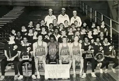  ?? Courtesy of Ken Balkey/Pitt athletics ?? Pitt’s 1971 indoor track and field team poses for a team photo. In uniform behind the distance medley relay record banner, from left: Jerry Richey, Smittie Brown, Michael Schurko and Ken Silay.