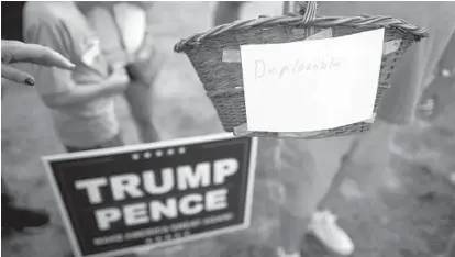  ?? MARK MAKELA/GETTY IMAGES ?? A Donald Trump supporter in Pennsylvan­ia displays a literal interpreta­tion of Hillary Clinton’s recent comment that half of Trump’s supporters in the presidenti­al race fit into a “basket of deplorable­s.”