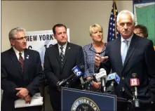  ?? GLENN GRIFFITH - MEDIANEWS GROUP ?? Rensselaer County Clerk Frank Merola lends his support to Sen. Jim Tedisco’s opposition to the governor’s license plate proposal at a press conference Wednesday. Standing behind him, left to right are Sen. Jim Tedisco, Saratoga County Clerk Craig Hayner, Assemblywo­man Mary Beth Walsh, and partially hidden, Herkimer County Clerk Sylvia Rowan.