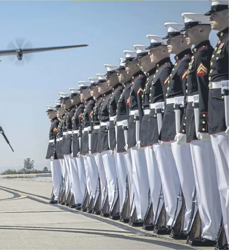  ?? ?? Corporal Gerald Wells III, rifle inspector, Silent Drill Platoon, conducts a rifle inspection during the Blue Angels’ “Fat Albert” C-130J Super Hercules fly-over at Marine Corps Air Station, Yuma, Arizona. The Silent Drill Platoon, the US Marine Drum and Bugle Corps and the Marine Corps Color Guard are about to show off their skills on a Us-wide Battle Color Detachment Tour