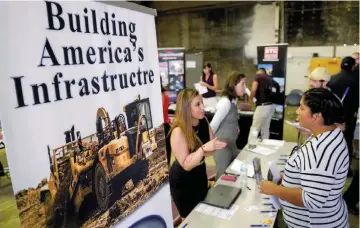  ?? — Reuters ?? A recruiter talks with a job seeker at the Constructi­on Careers Now! hiring event in Denver, Colorado US.