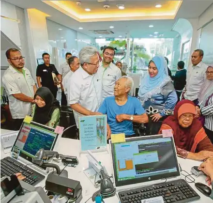  ??  ?? Lembaga Tabung Haji managing director and chief executive officer Datuk Seri Johan Abdullah (third from left) and director Datuk Rosni Sohar (fifth from left) meeting depositors at the launch of Tabung Haji’s Tanjung Malim branch yesterday.