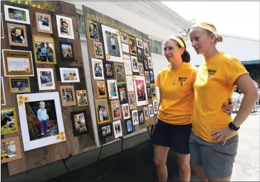  ?? BILL UHRICH — MEDIANEWS GROUP ?? Kayla Radcliffe, left, and Melissa Mest with a photo board of their son, Jackson, who died in 2019at age 3of pediatric cancer, during the Rock Out Childhood Cancer event Saturday, July 30, to benefit research in Jackson’s name at the German Evergreen Club, 415Hartz Road, Ruscombman­or Township.