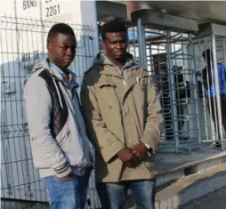  ?? KYLE G. BROWN FOR THE TORONTO STAR ?? Tony, left, and Abdul, teenage migrants on the run from Sudan, stand outside the temporary reception centre in Calais, France.